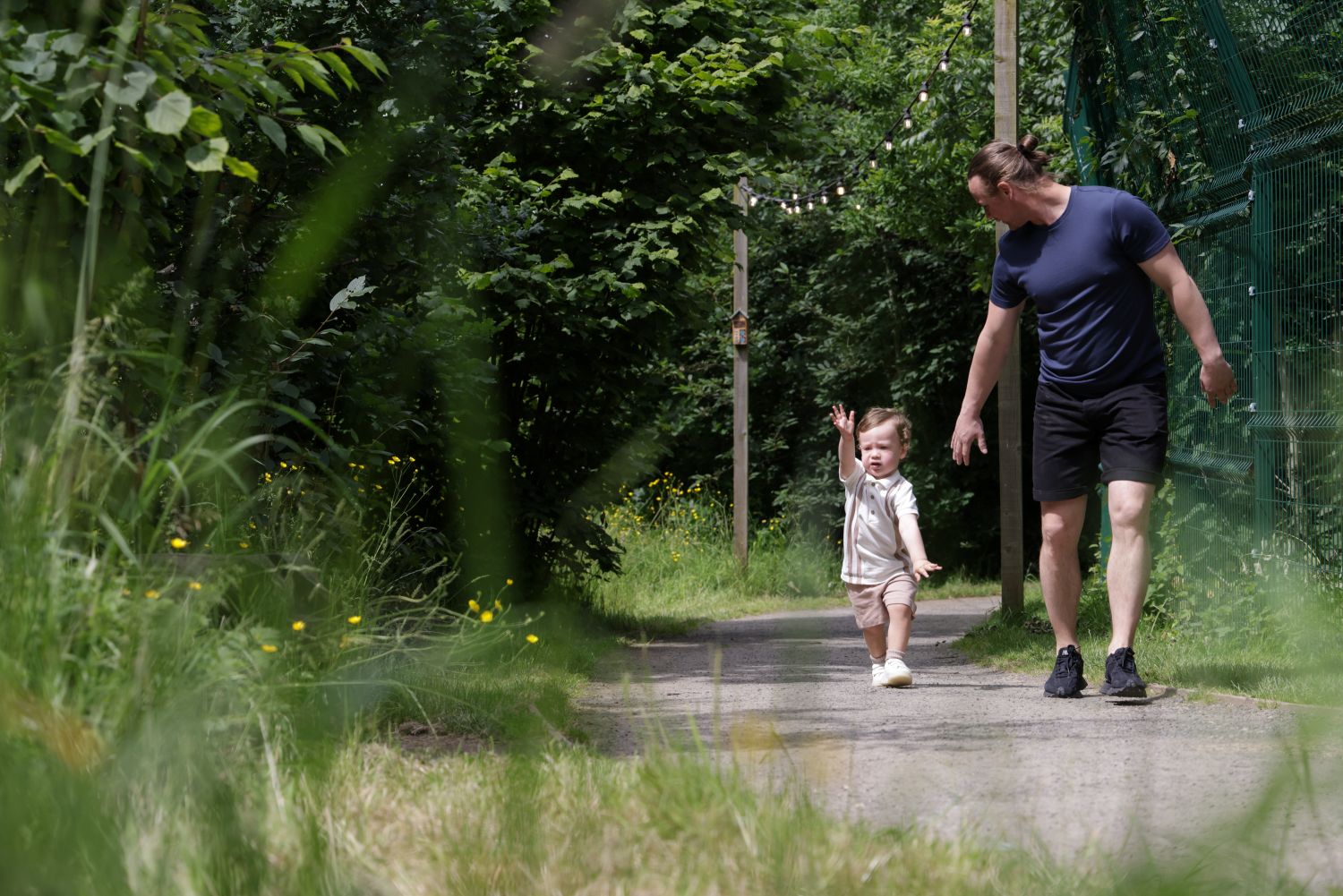 Father and child on an accessible path in the woodland walk
